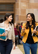 Postgraduate students walking in UQ's Great Court