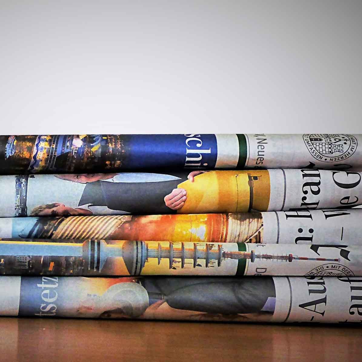 This is an image of a stack of newspapers sitting on a table