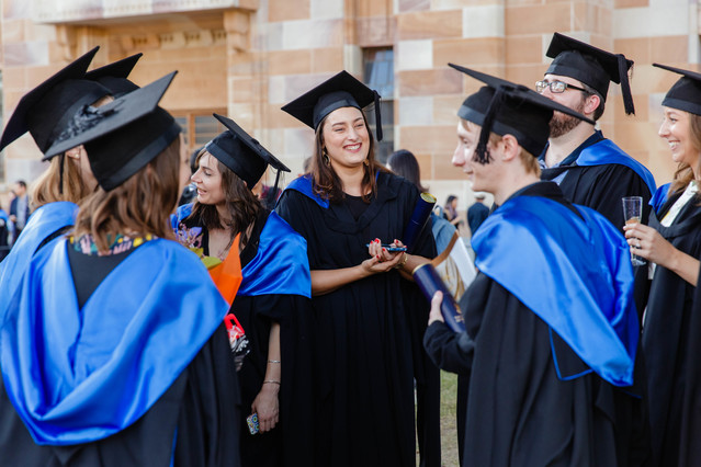 graduates gathering in gowns and hats