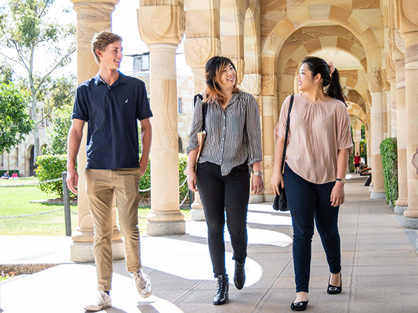 three scholarship recipients walking through UQ's Great Court