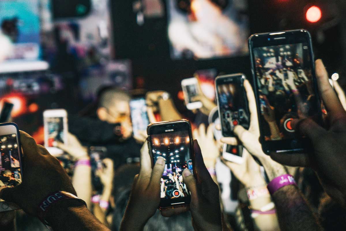 many mobile phones held aloft