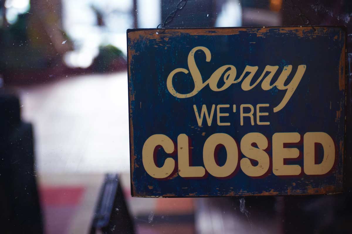 sorry we're closed sign on glass door