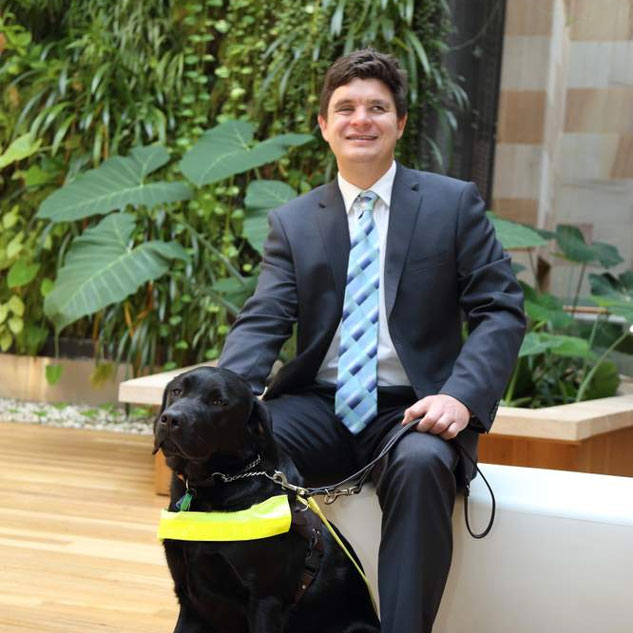 Associate Professor Paul Harpur with his guide dog, Sean