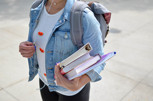 girl walking with text books 