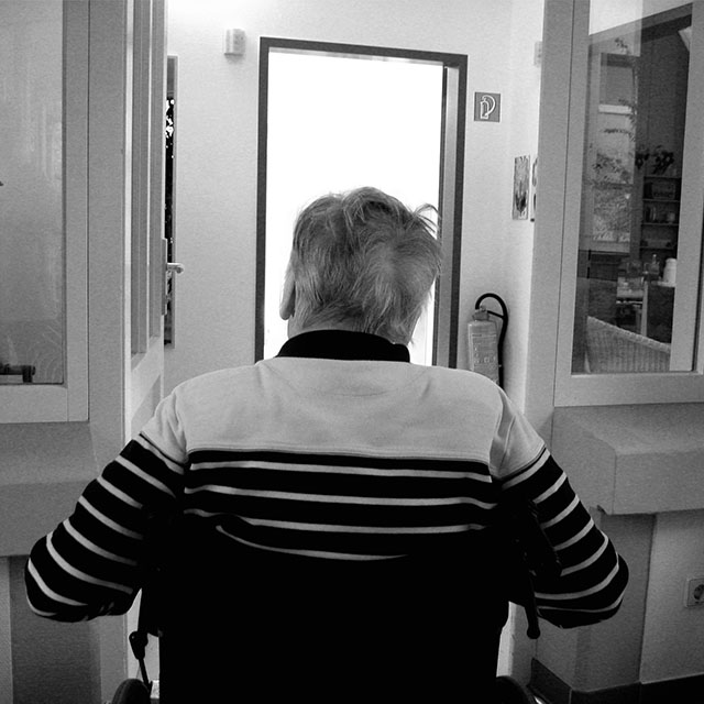 aged man in wheelchair in care facility