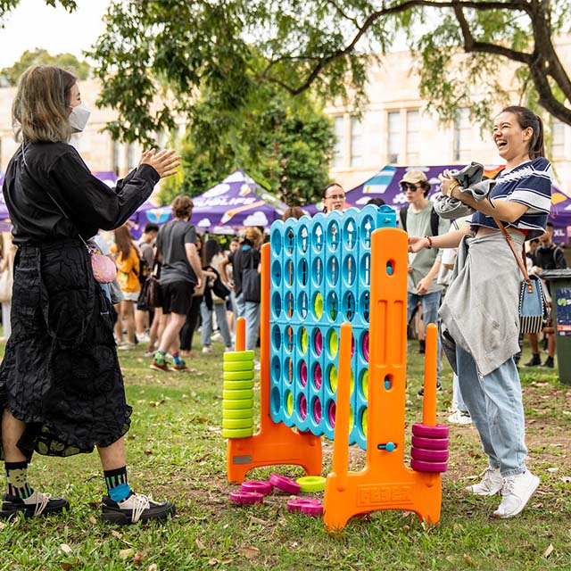 Students playing lgiant Connect Four at Orientation Festival.