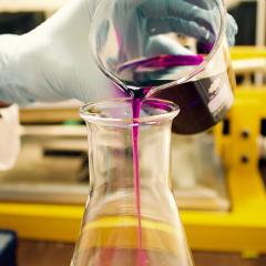 Pink liquid being poured in a lab