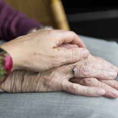 This is an image of the hands of two elderly people