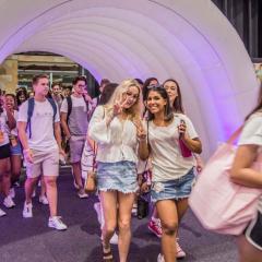Students entering the BELfest event via a purple lit up tunnel