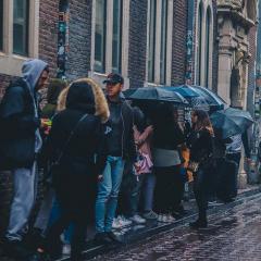 people waiting in line in the rain