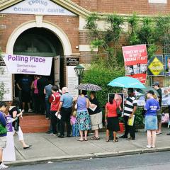 people lining up to cast their vote in an Australian election. 
