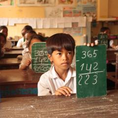 Cambodian school children doing math in classroom