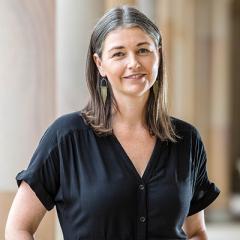 Profile photo of Dr Cassandra Chapman standing in UQ's Great Court