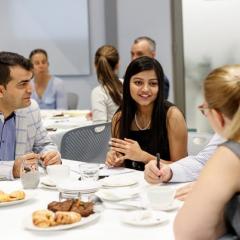 researchers, students and industry discussing at a table