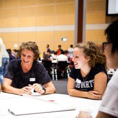 students having fun partaking in an icebreaker activity at an orientation event.