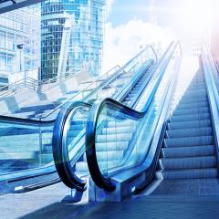 Two up escalator with scrapped in the distance 